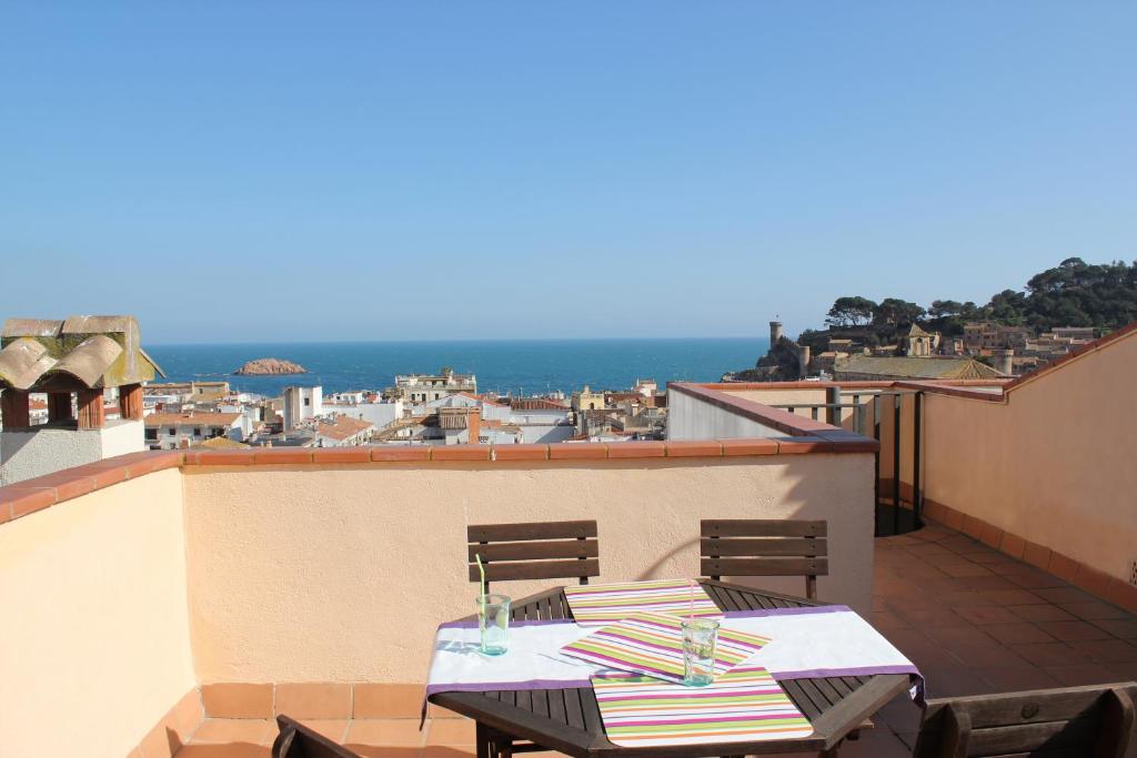 a patio with a table and chairs on a balcony at Holiday Tossa Apartment in Tossa de Mar