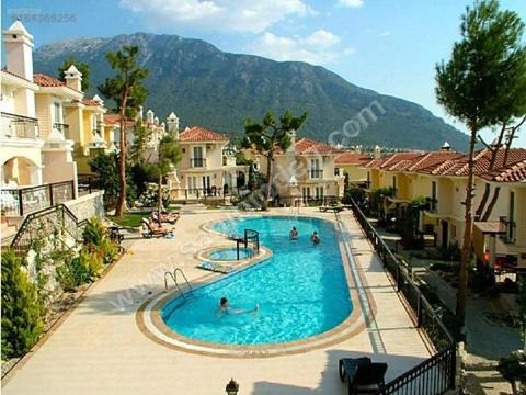 a large swimming pool with people in a resort at Wonderful Villa In Oludeniz 2 in Kayakoy