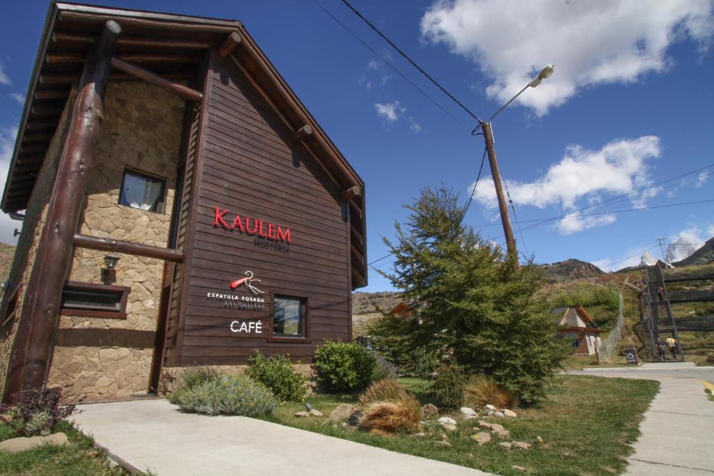 a building with a sign on the side of it at Kaulem Hotel Boutique in El Chalten