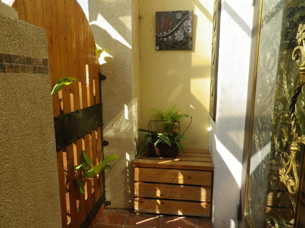 a hallway with a wooden door and some plants at Alongs Garden in Hengchun South Gate