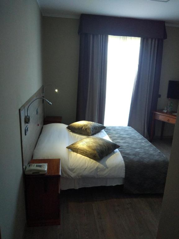Postel nebo postele na pokoji v ubytování Albergo Ristorante San Biagio