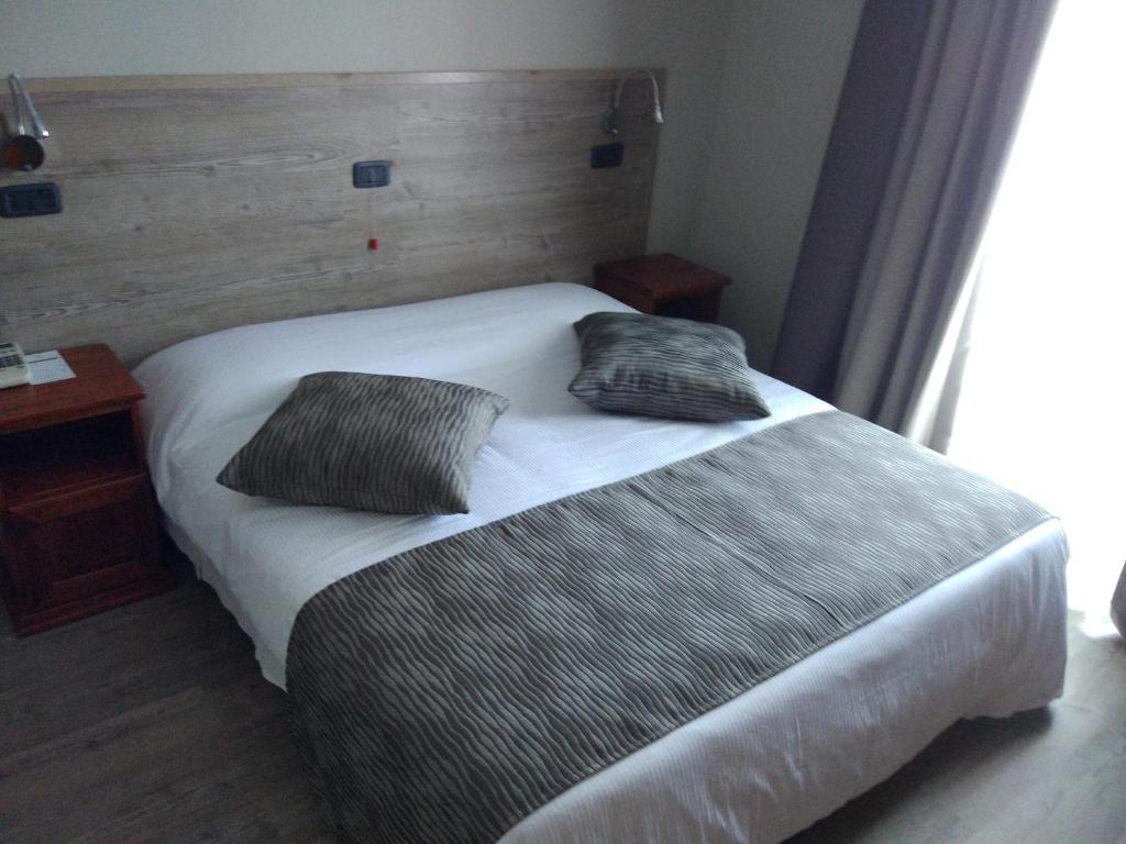 Postel nebo postele na pokoji v ubytování Albergo Ristorante San Biagio