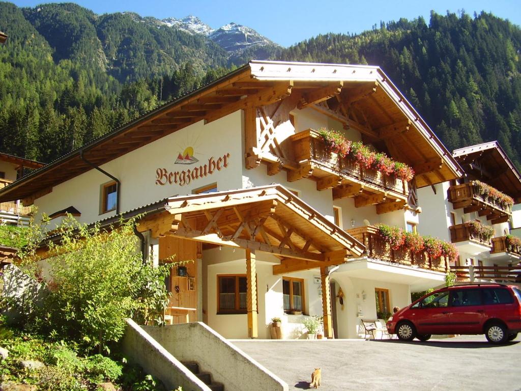 a building with a red car parked in front of it at Haus Bergzauber in Neustift im Stubaital