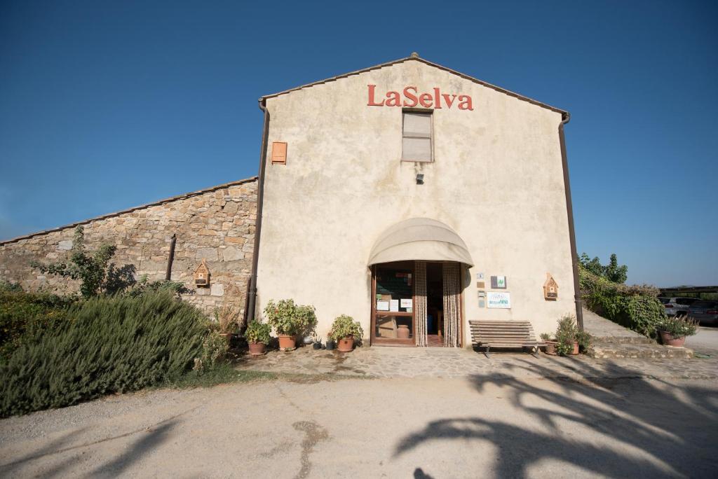 ein Gebäude mit einem Schild an der Seite in der Unterkunft LaSelva in Albinia