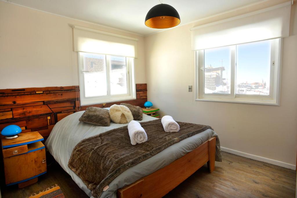 a bedroom with a bed with towels on it at Apart Hotel Bianco in El Colorado