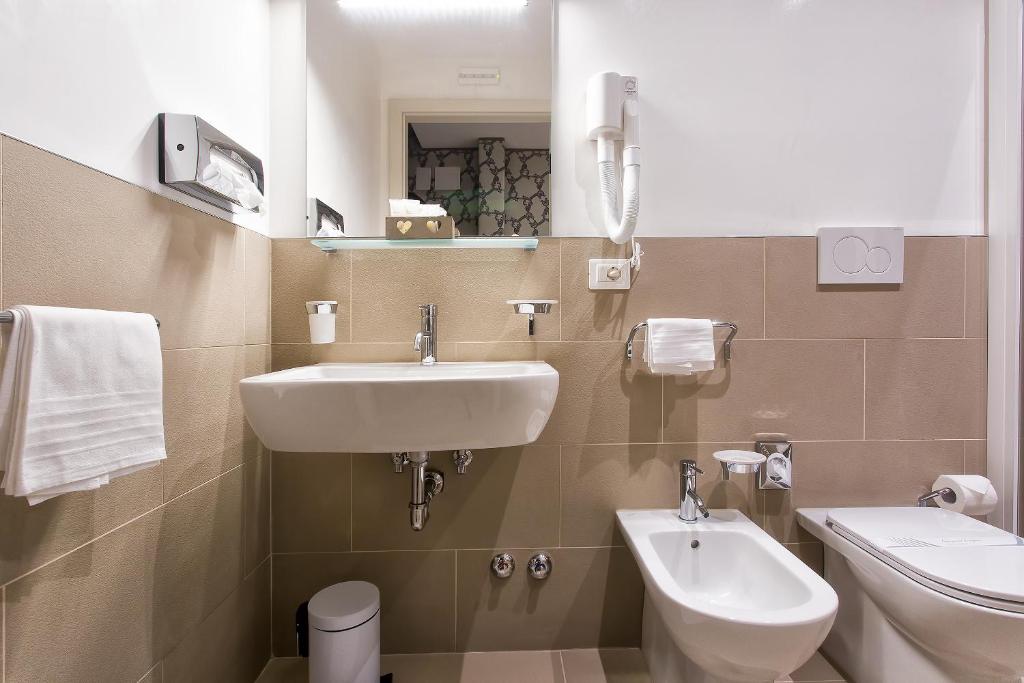a bathroom with a sink and a toilet at Hotel Ca' Nobile Corner in Venice