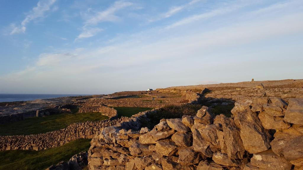 a view of a rocky mountain with the ocean in the background at An Creagán Rooms in Inisheer