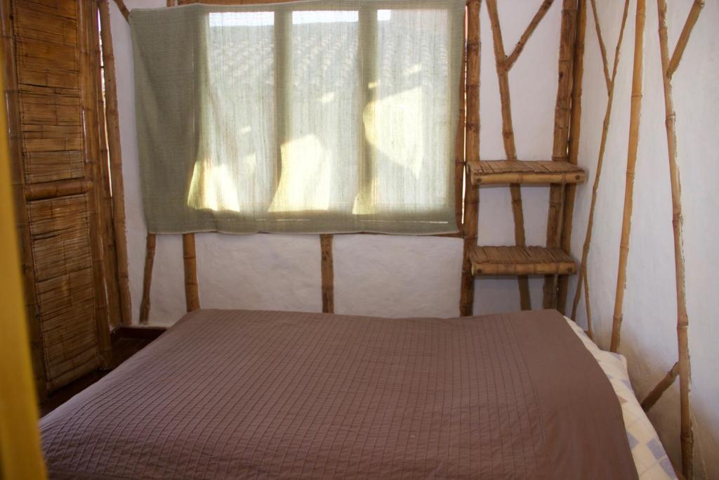 Una cama o camas en una habitación de Hotel La Montoya