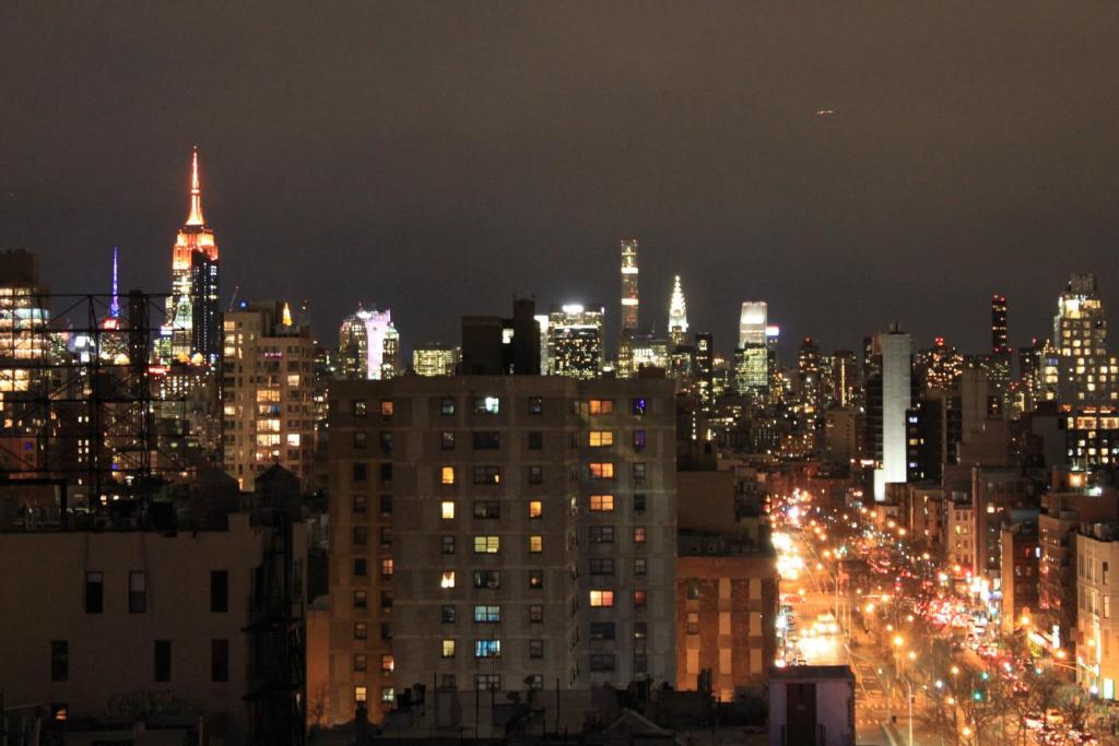 a view of a city at night with lights at Hotel Richland LES in New York