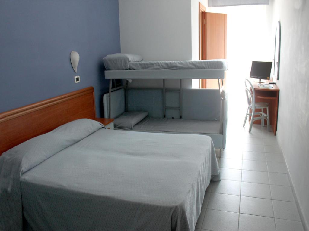 Postel nebo postele na pokoji v ubytování Hotel Acquario