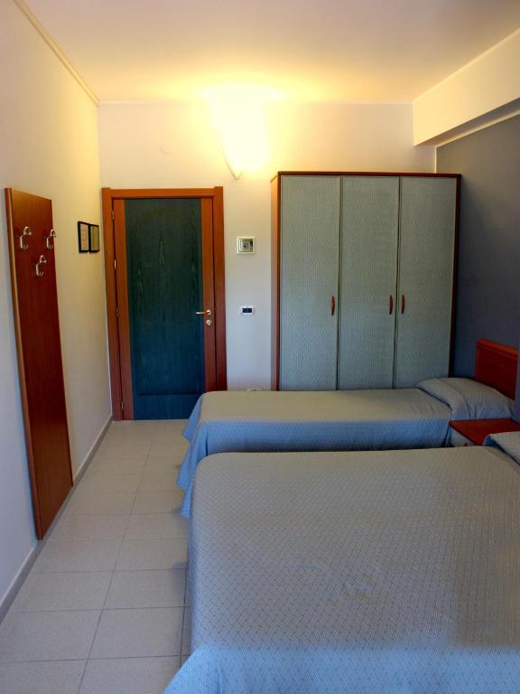 Postel nebo postele na pokoji v ubytování Hotel Acquario