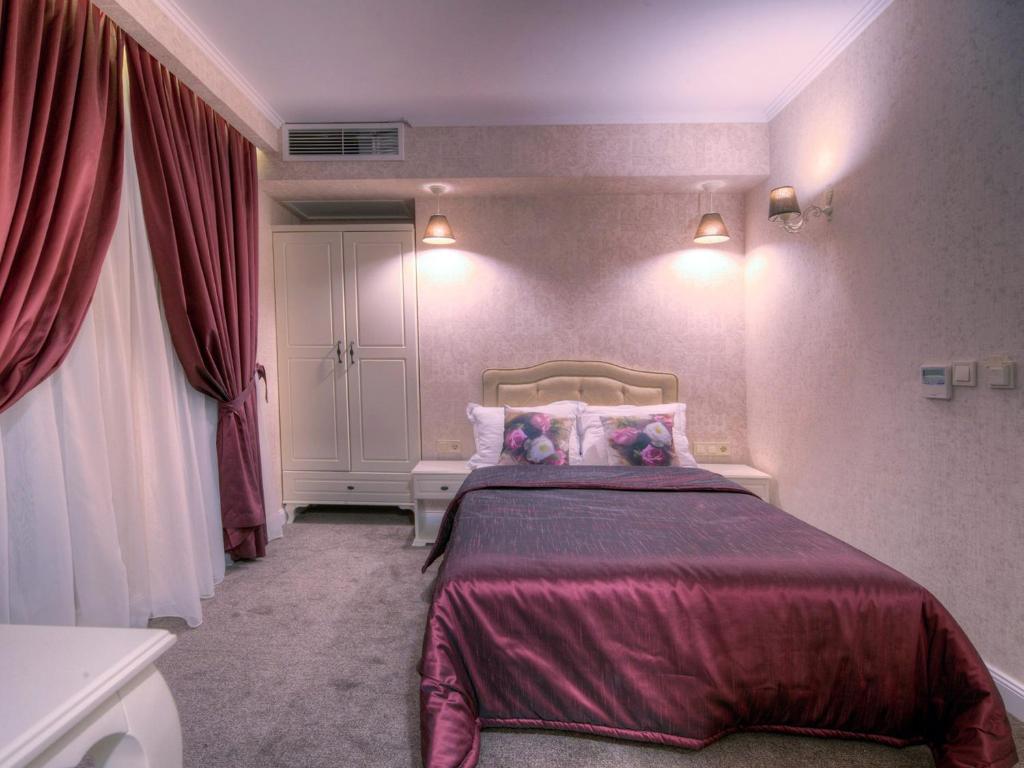 Postel nebo postele na pokoji v ubytování Family Hotel Agoncev