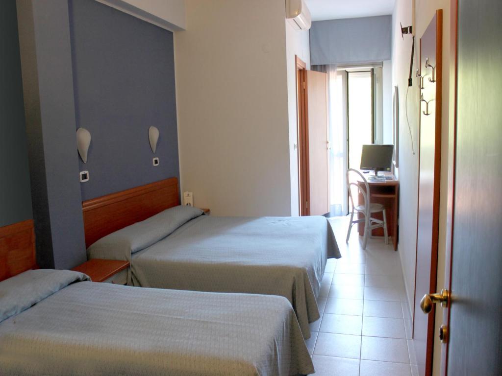 Postel nebo postele na pokoji v ubytování Hotel Acquario