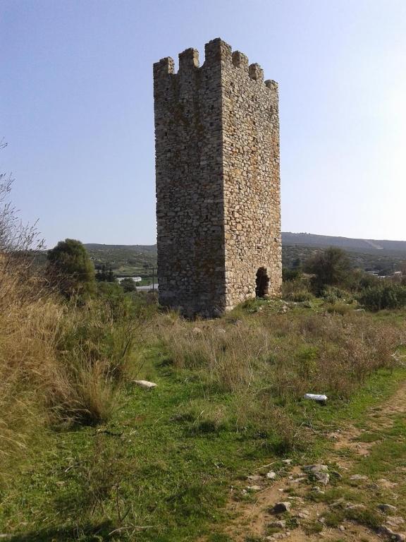 a tall tower on top of a grassy hill at Marathon Eco Stay in Marathon