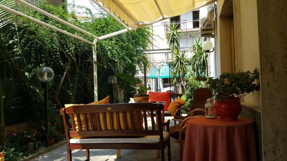 a patio with a chair and a table and an umbrella at Hotel Milanesina in Alassio