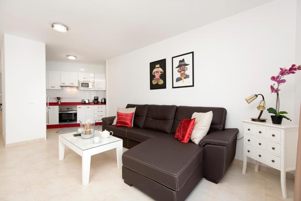 a living room with a couch and a table at Apartment Old Town in Puerto del Carmen