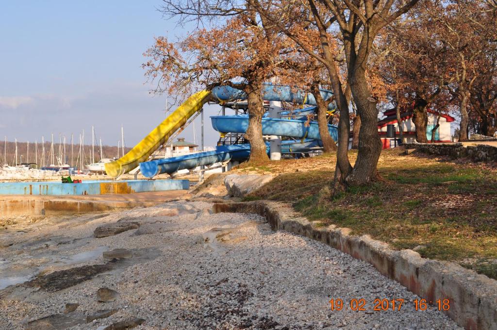 a playground with a slide in the water at Apartman Dragica in Poreč