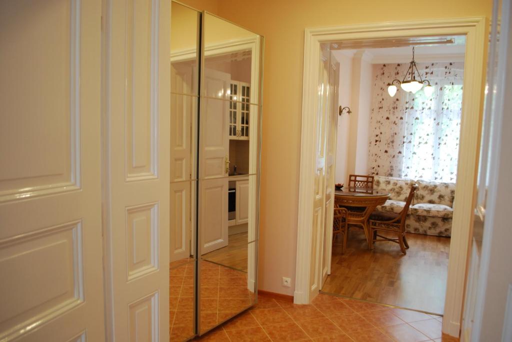 a hallway with a glass door and a dining room at Jurincom apartments Masaryka in Karlovy Vary