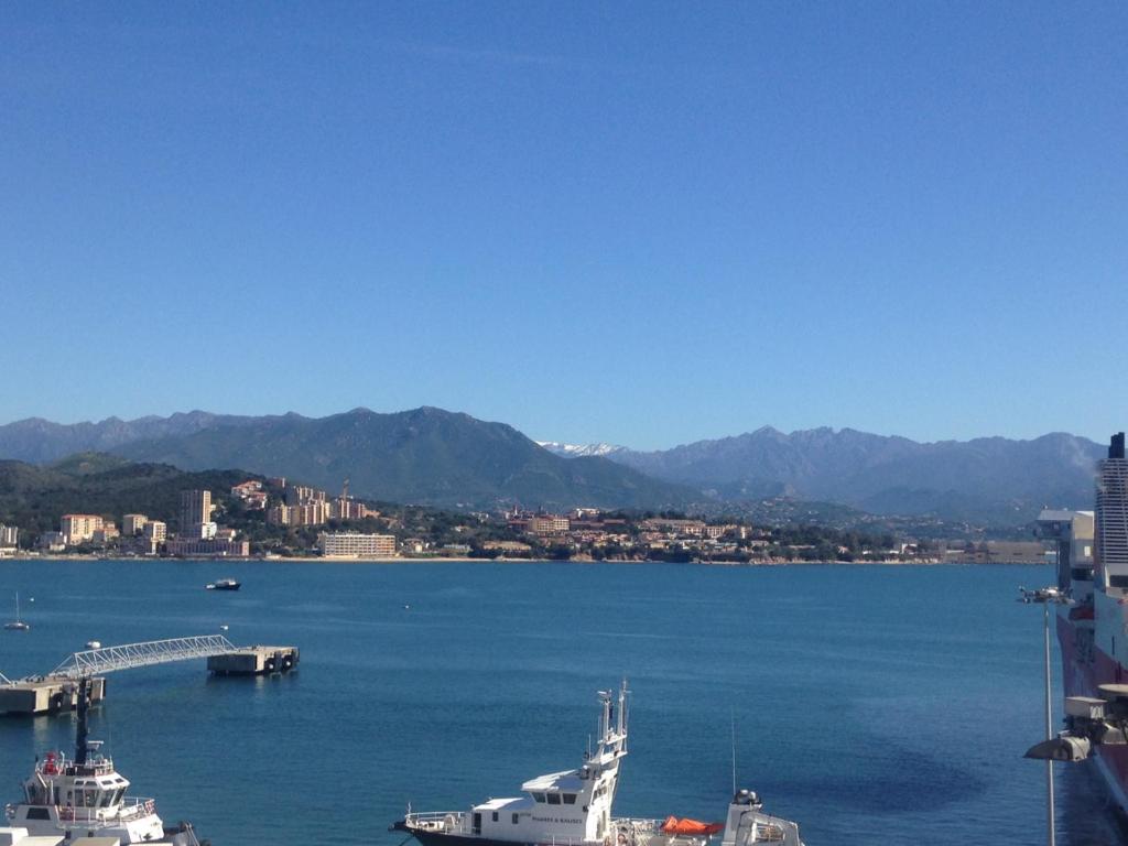 a large body of water with two boats in it at Hotel le Dauphin in Ajaccio