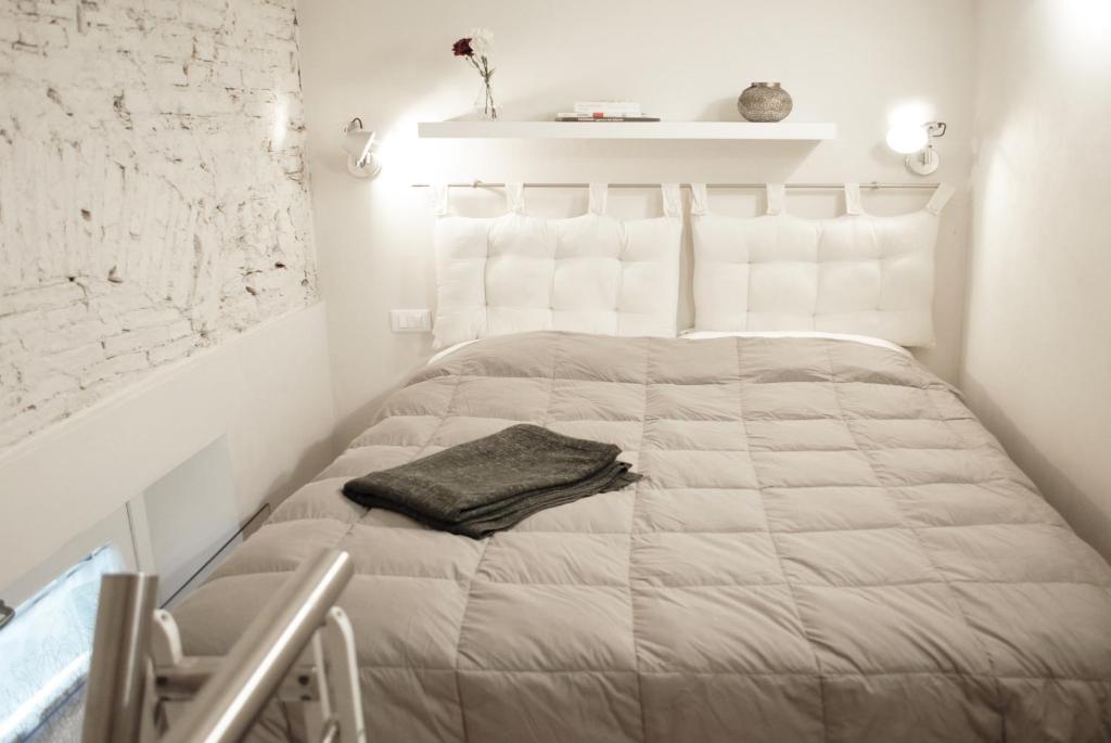 a white bedroom with a bed with a pillow on it at A Dream in Florence in Florence