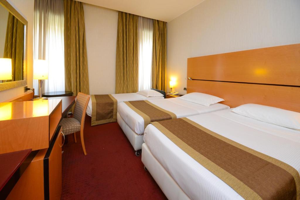 Postel nebo postele na pokoji v ubytování Hotel Igea