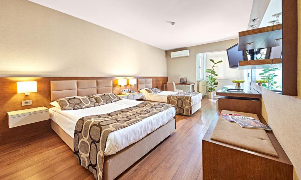 Postel nebo postele na pokoji v ubytování The New Hotel Zeybek