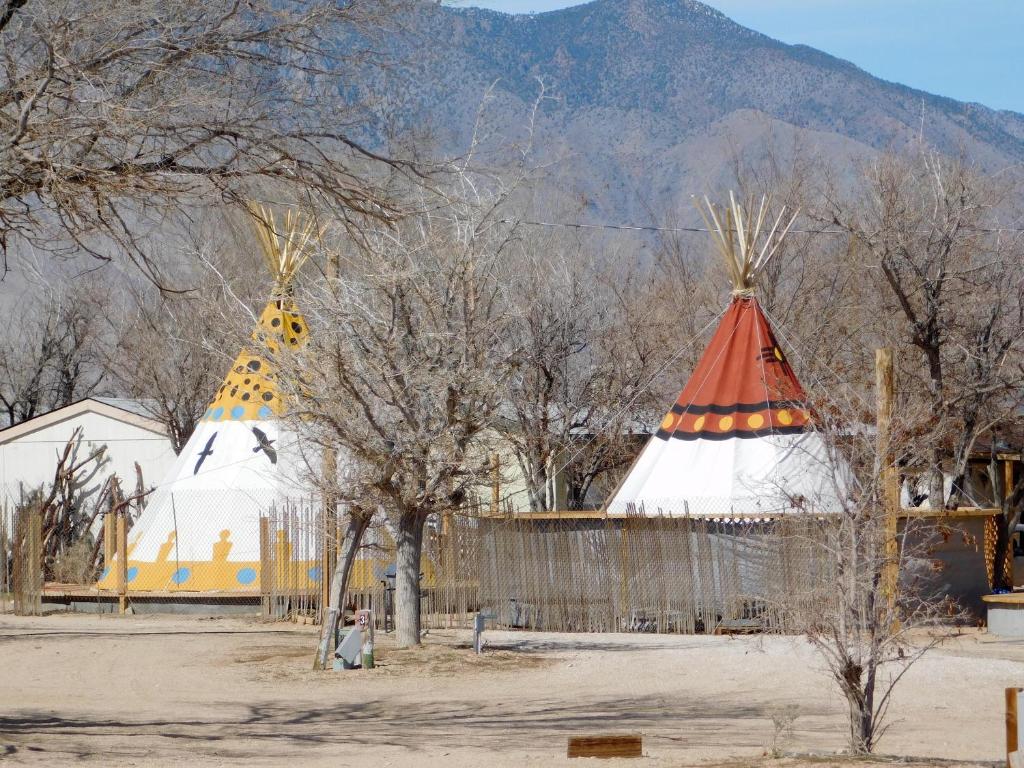 two pointed domes with trees and mountains in the background at Olancha RV Park and Motel in Olancha