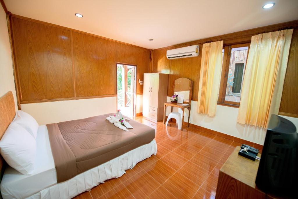 a bedroom with a bed and a tv in it at Poonsap Resort in Ko Lanta
