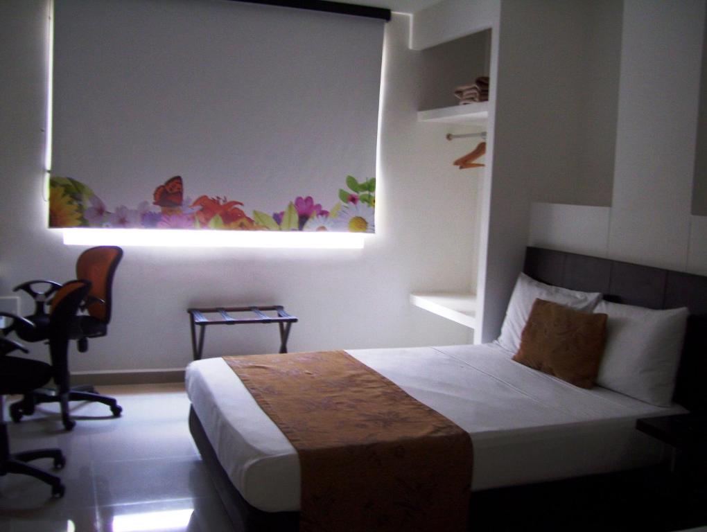 Cama ou camas em um quarto em hgo hotel