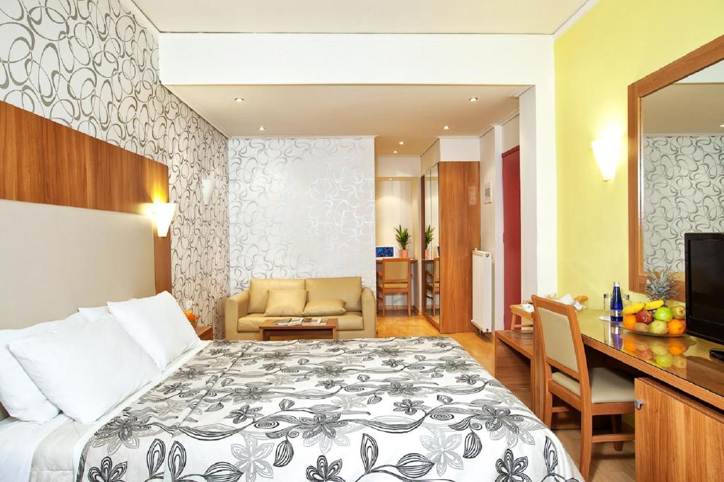 a hotel room with a bed and a living room at Leto Boutique Hotel Agrinio in Agrinio