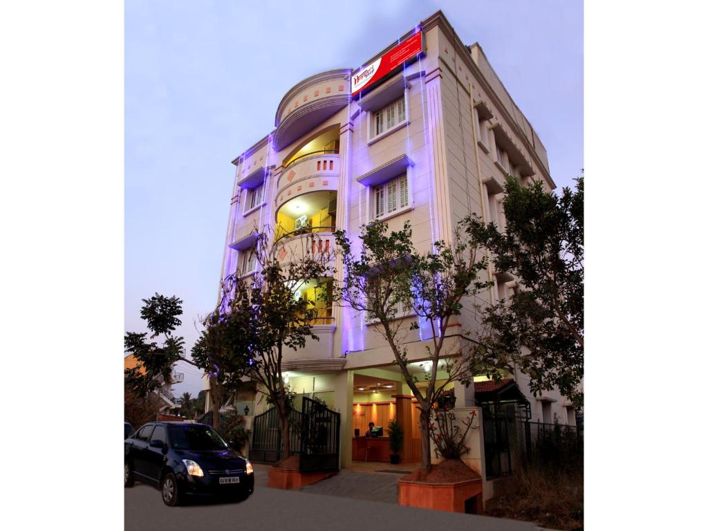 a building with a car parked in front of it at Hoppers Stop Yelahanka in Bangalore