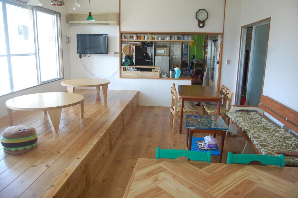 a living room with a couch and a table at Minshuku Namisou in Iriomote