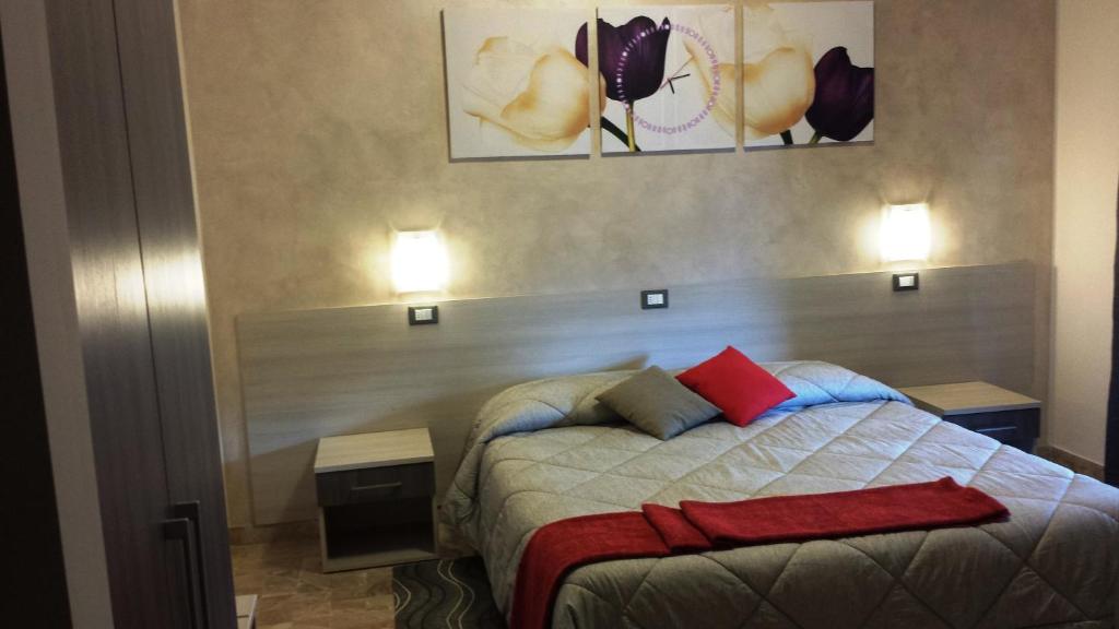 a bedroom with a bed with red pillows on it at B&B Monté in Montesilvano