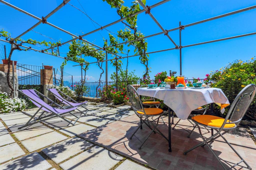 een tafel en stoelen op een patio bij Villa Matilde Amalfi in Amalfi