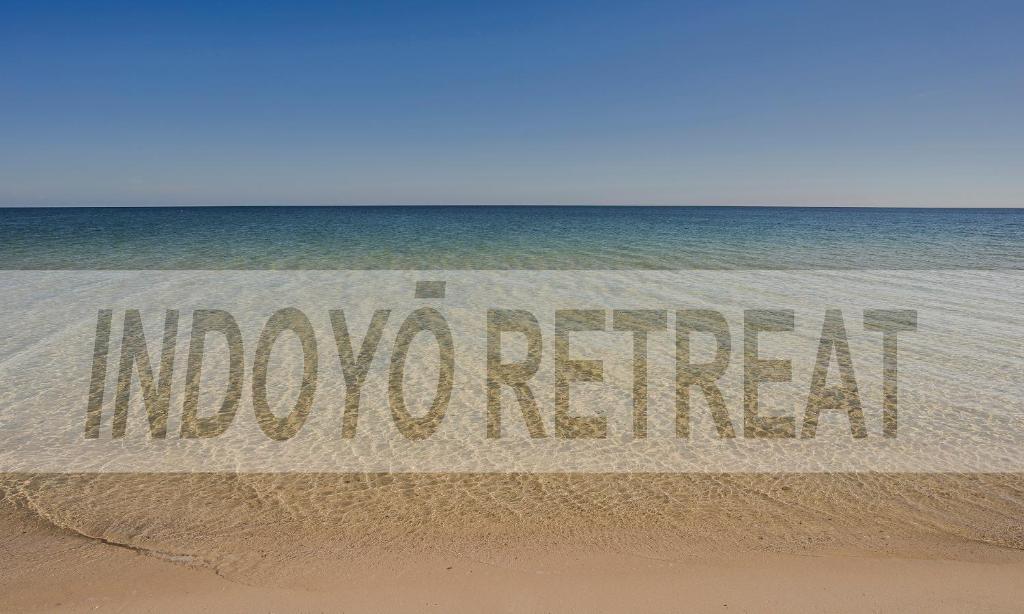 a sign on the beach that reads underwater at Indoyo Retreat in Busselton