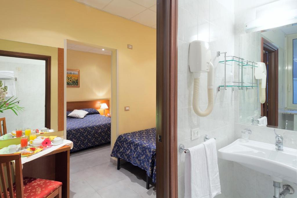 Postel nebo postele na pokoji v ubytování Hotel Oriente