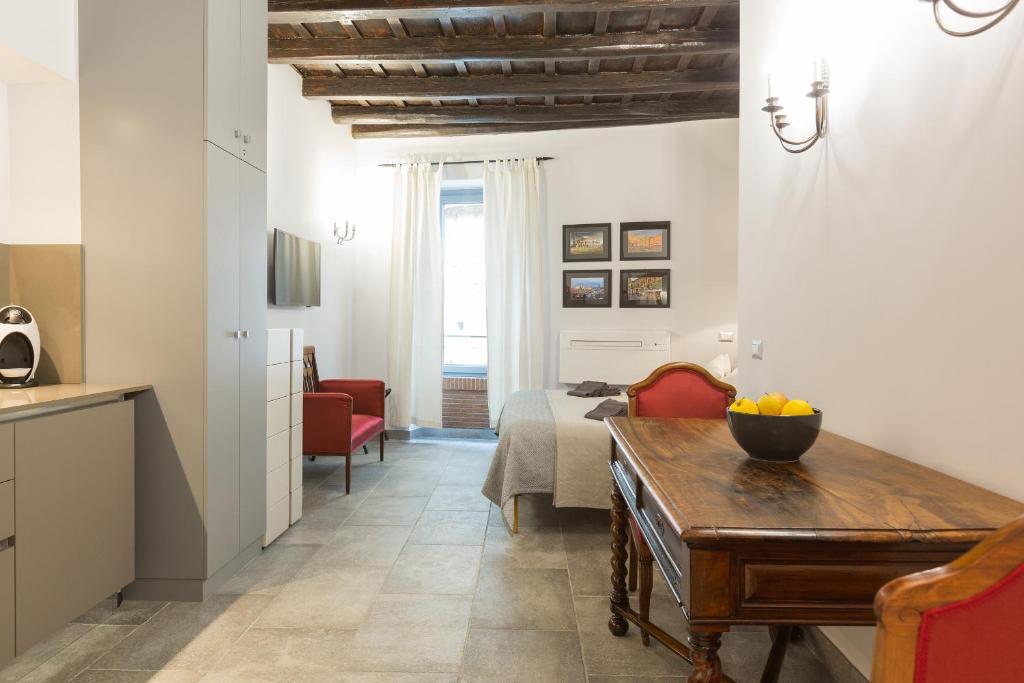 a living room with a table and a room with a bed at Roman Forum Suite in Rome