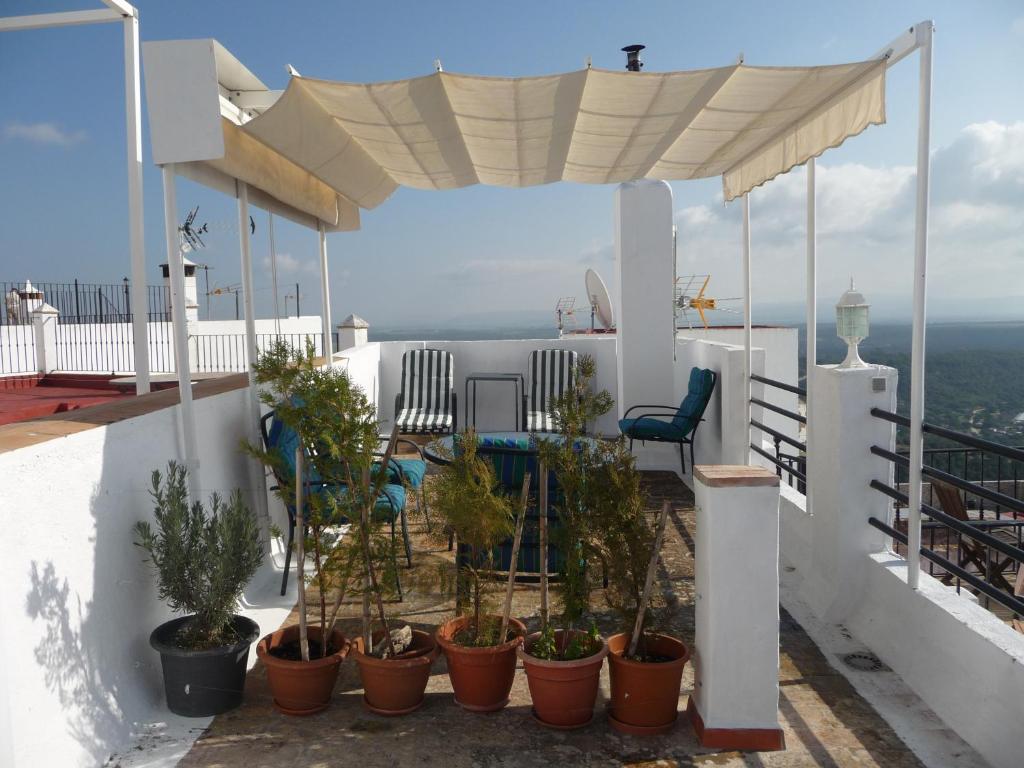 a balcony with potted plants on a house at Casa Sol in Vejer de la Frontera