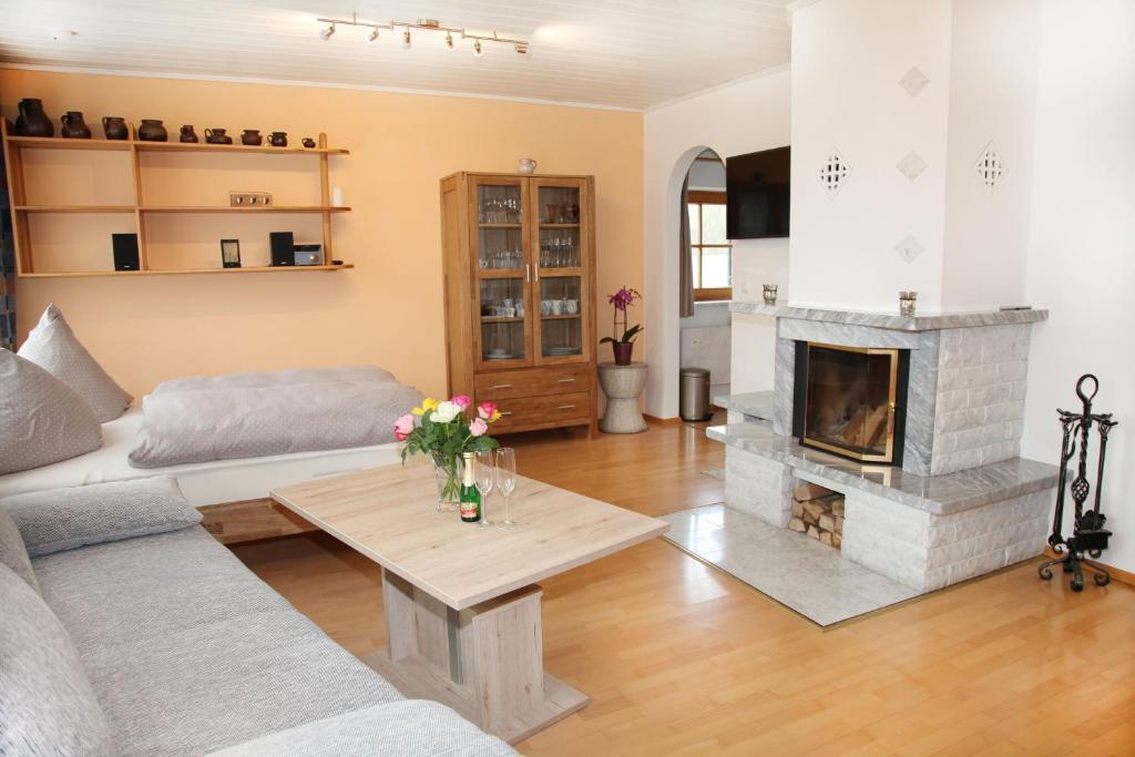a living room with a couch and a fireplace at Chiemsee Comfort-Bungalow mit Garten in Rimsting