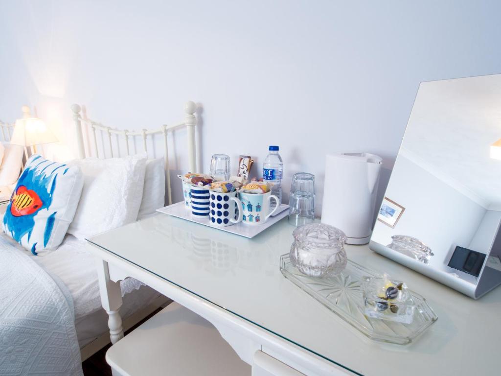 a white table with some food on it next to a couch at The Coast Yard B & B and Garden Chalets in Selsey