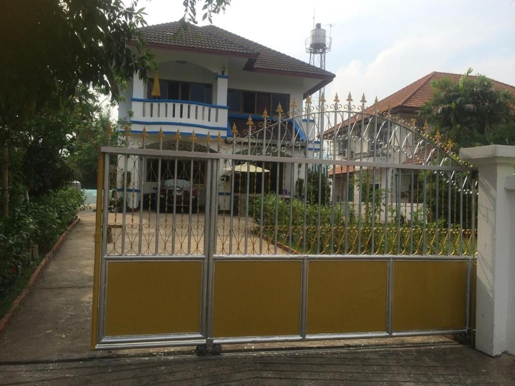 a gate in front of a house at Home Baan Chiang Mai in Chiang Mai