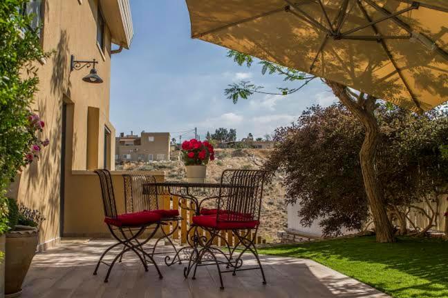 a patio with a table and chairs on a patio at Zimmer you dreamed of in Arad