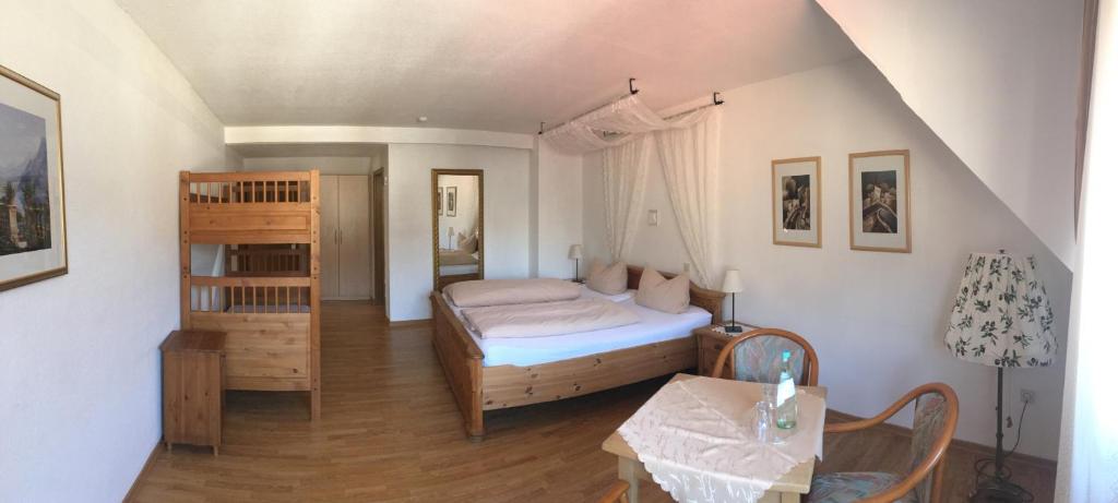 a small bedroom with a bed and a table at Hotel Feiden Garni in Ediger-Eller