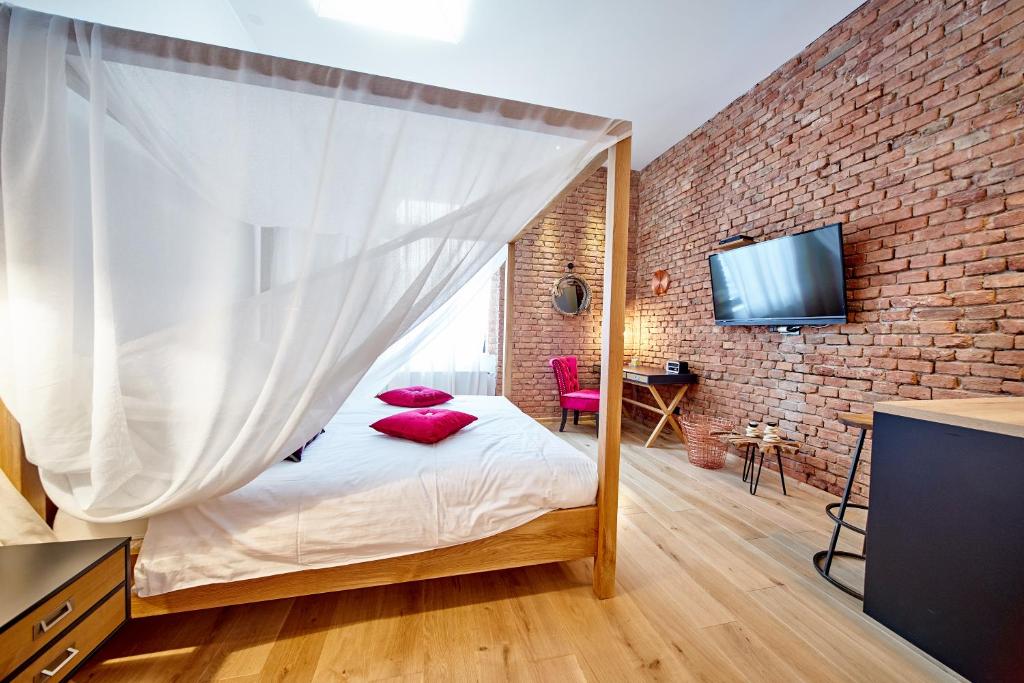 a bedroom with a bed with a mosquito net at Indigo Centar in Zagreb