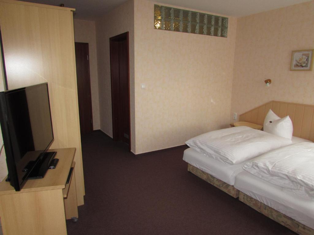 Postel nebo postele na pokoji v ubytování Pension Am Heiderand