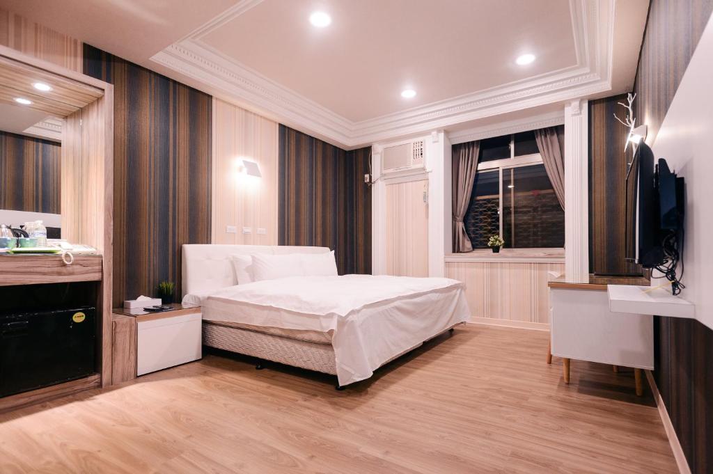 Postel nebo postele na pokoji v ubytování Guest Motel-Zhubei