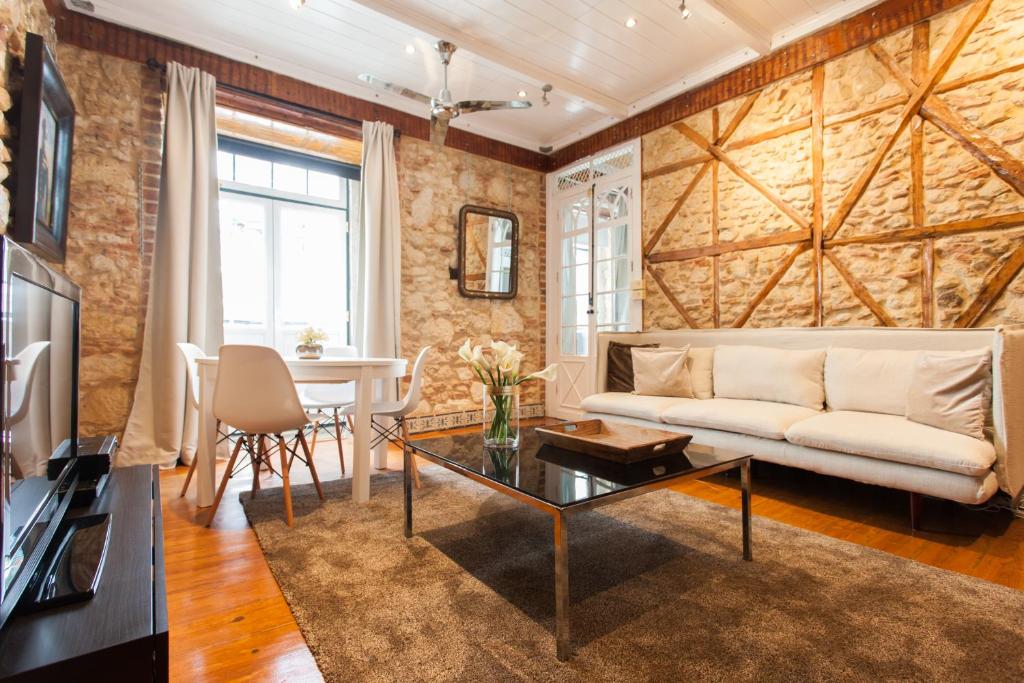 a living room with a couch and a table at Bairro Alto Lusitania Dream in Lisbon