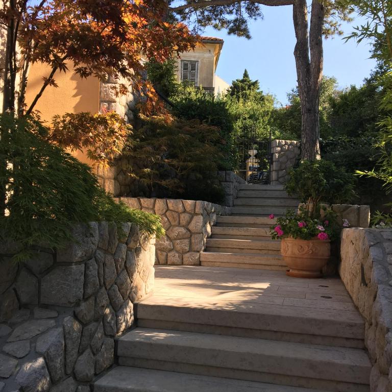 a set of stone stairs leading up to a house at Guest House Villa Dagmar in Crikvenica