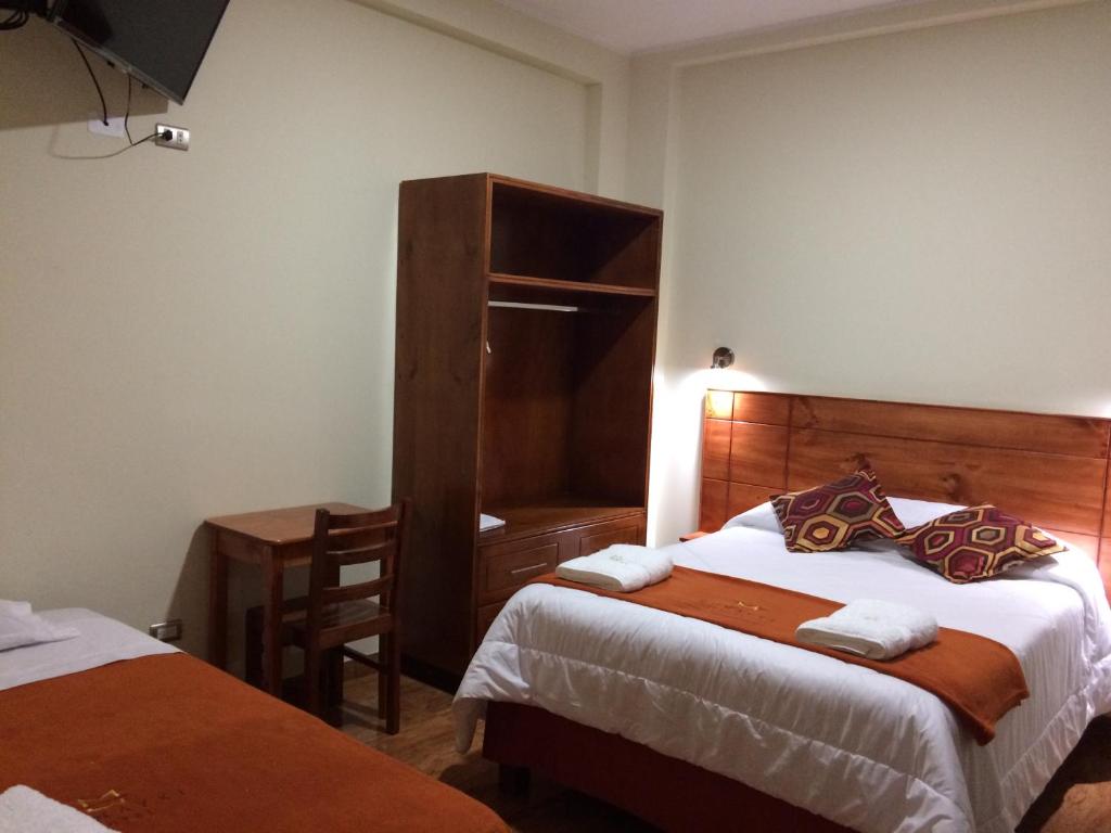 Postel nebo postele na pokoji v ubytování Munayki Hotel