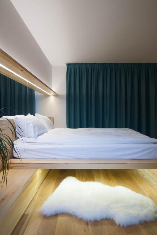 a bedroom with a bed with a green curtain at Garden House in Timişoara